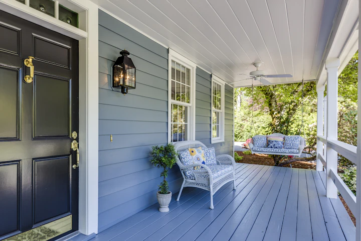 A welcoming home porch with a swing and seating
