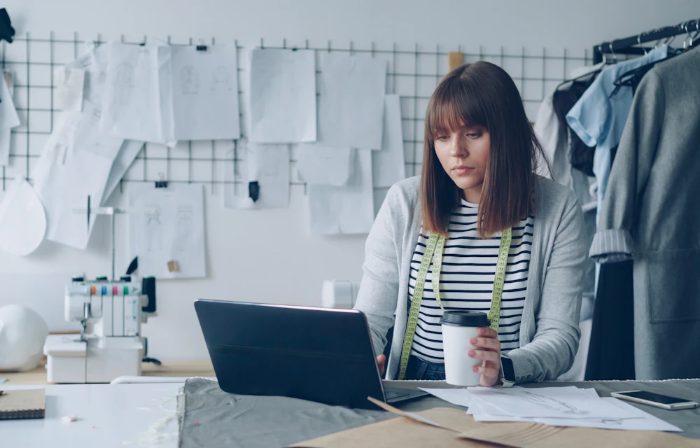 Illustrative photo of a small-business owner working at a laptop in her studio