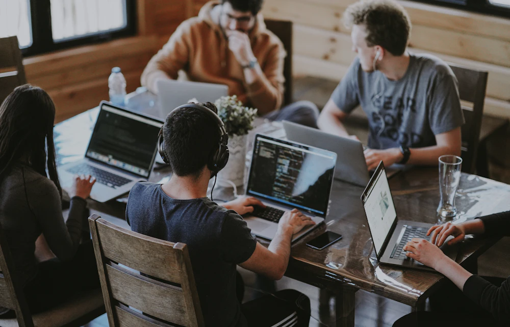 Illustrative photo of a software team working together at laptops